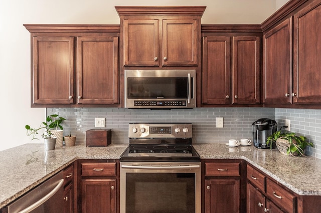 kitchen with appliances with stainless steel finishes, tasteful backsplash, and light stone countertops