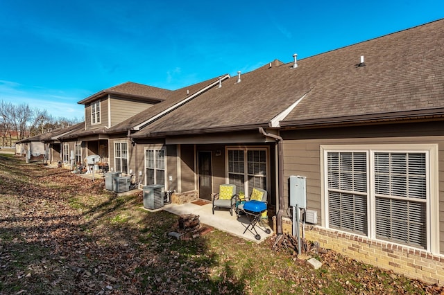 back of property featuring a patio and central air condition unit