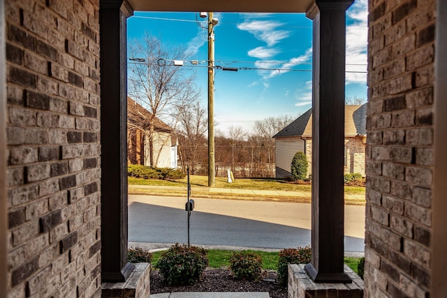 exterior space featuring brick wall