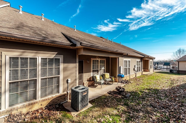 rear view of property with cooling unit and a patio