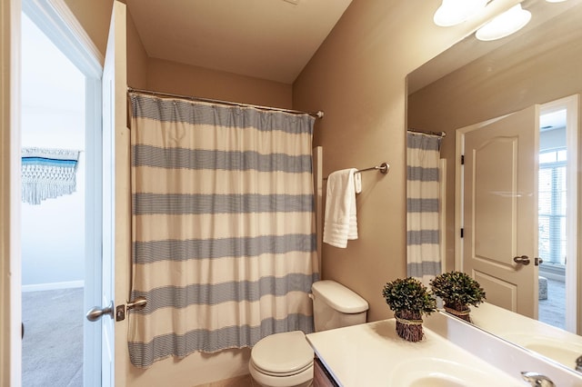 bathroom featuring vanity, toilet, and walk in shower