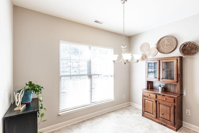 dining space with plenty of natural light and a chandelier