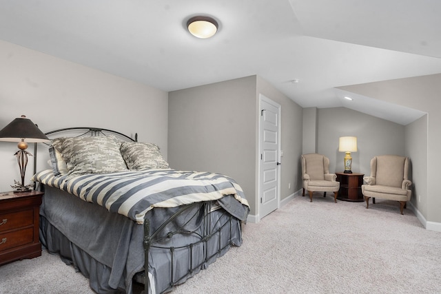 bedroom featuring vaulted ceiling and light carpet