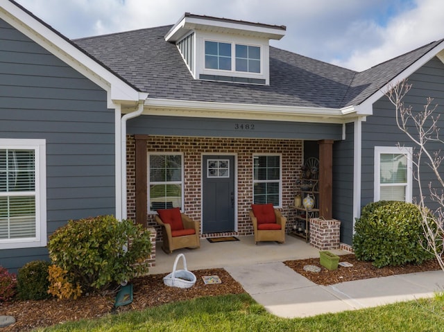 view of exterior entry featuring a patio area