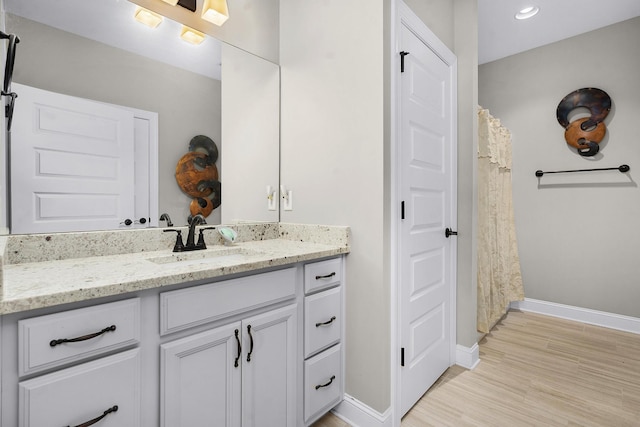 bathroom featuring hardwood / wood-style flooring and vanity