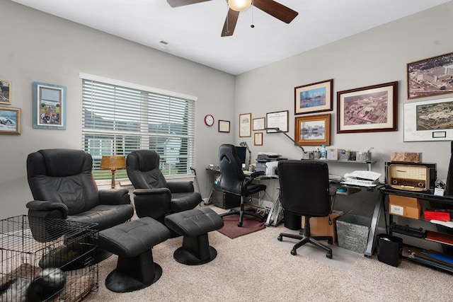 carpeted office space with ceiling fan