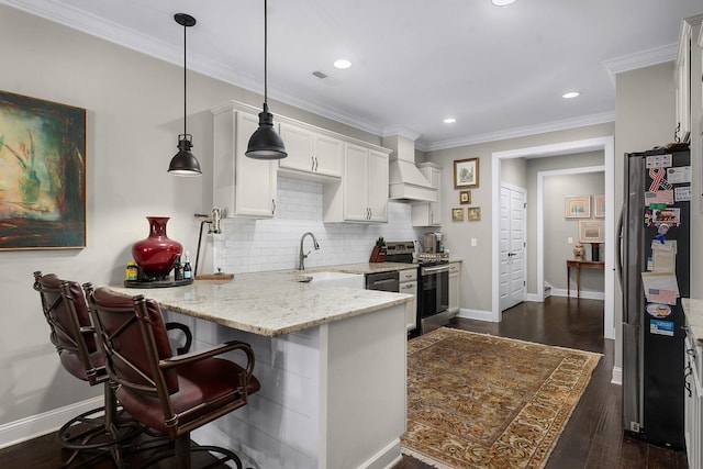 kitchen with pendant lighting, sink, a breakfast bar area, white cabinetry, and stainless steel appliances