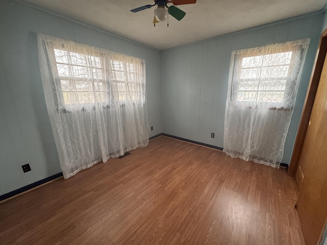 spare room with wood-type flooring and ceiling fan