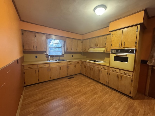 kitchen with sink, crown molding, white electric cooktop, light hardwood / wood-style flooring, and oven