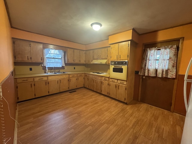 kitchen with sink, crown molding, wall oven, light hardwood / wood-style floors, and white gas cooktop