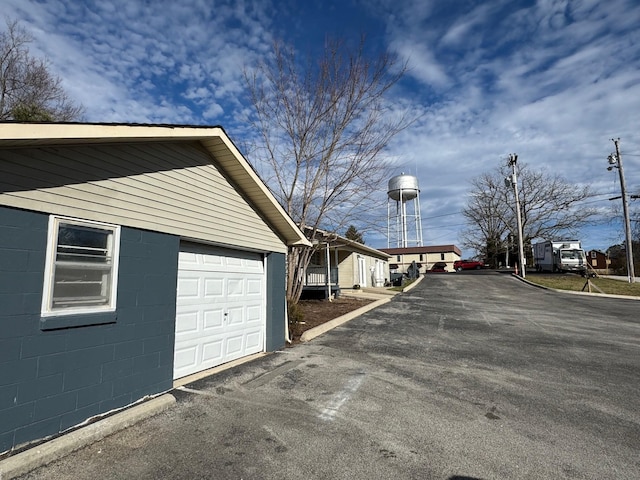 view of side of home with an outbuilding and a garage