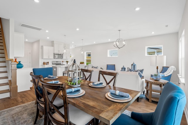 dining space with wood-type flooring