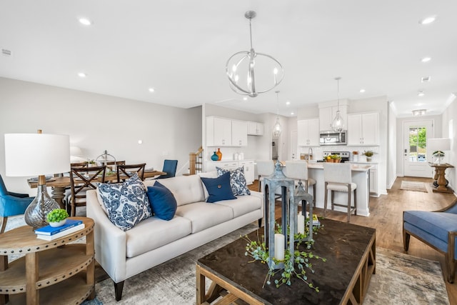 living room featuring light hardwood / wood-style flooring and a chandelier