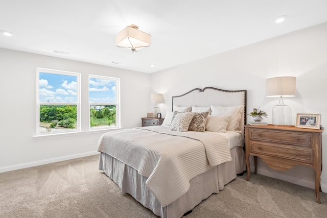 bedroom featuring light colored carpet