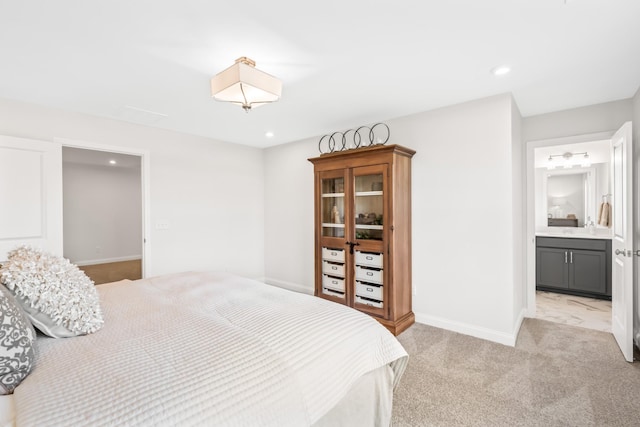 bedroom with light carpet and ensuite bath