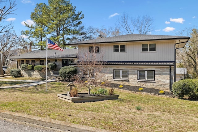 view of front of property featuring a standing seam roof, stone siding, metal roof, and a front yard