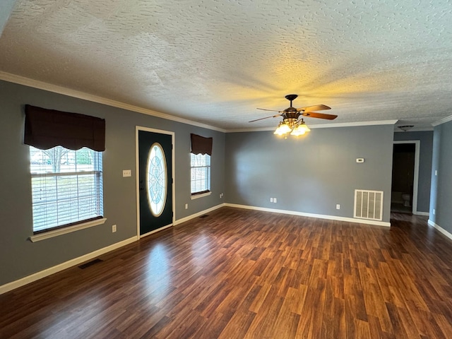 foyer entrance featuring dark wood finished floors, baseboards, visible vents, and ornamental molding