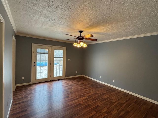 empty room with dark wood-type flooring, a ceiling fan, a textured ceiling, crown molding, and baseboards