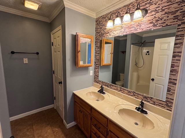 full bathroom with crown molding, toilet, and a sink