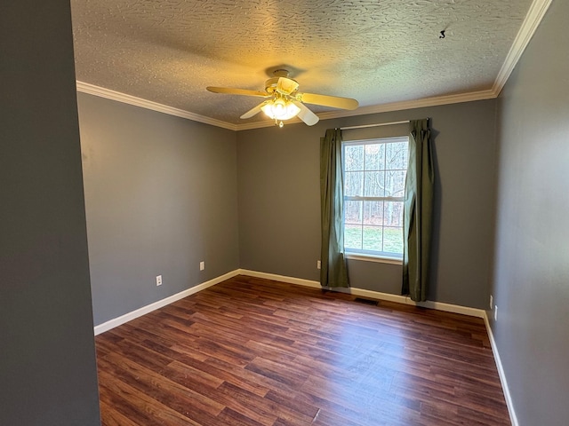 empty room featuring dark wood finished floors, baseboards, visible vents, and ornamental molding