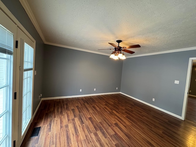 unfurnished room with dark wood finished floors, crown molding, and visible vents