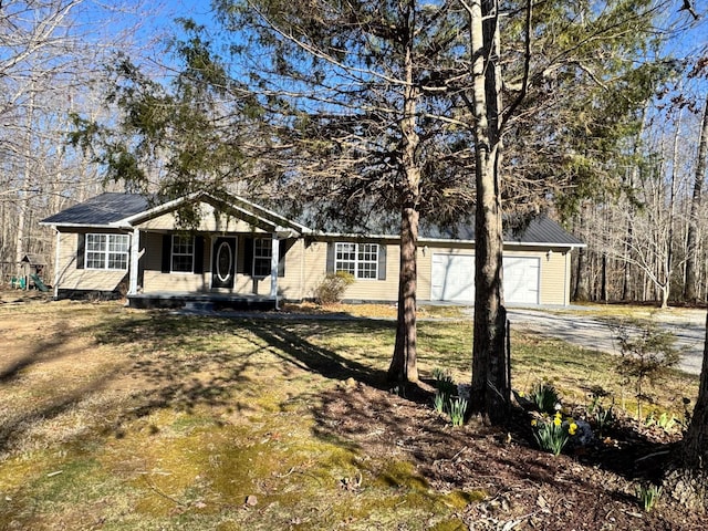 ranch-style house featuring a porch, concrete driveway, and a garage