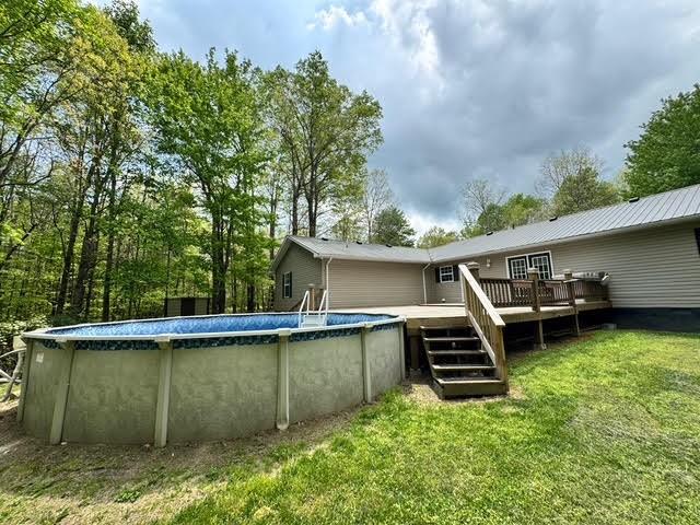 238 Laurens Ln, Grimsley, TN 38565 - rear view of house featuring a lawn, a deck, and an outdoor pool