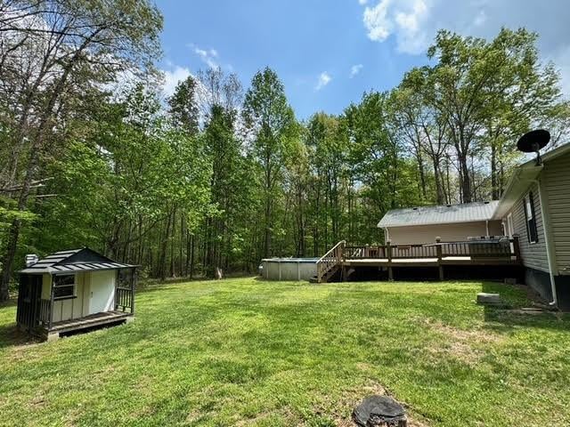 238 Laurens Ln, Grimsley, TN 38565 - view of yard with an outdoor structure, an outdoor pool, a storage shed, and a deck