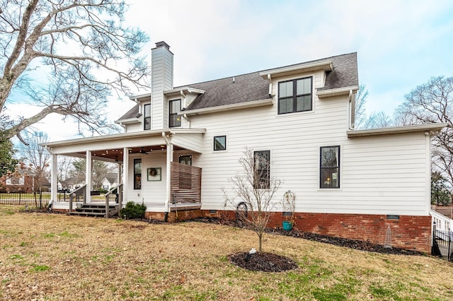 rear view of property with ceiling fan, a porch, and a lawn