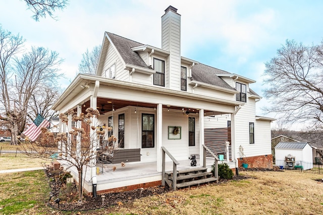 view of front facade featuring a front yard, ceiling fan, and a porch