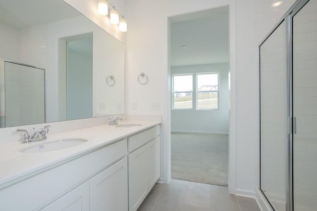 bathroom featuring vanity, a shower with door, and tile patterned floors