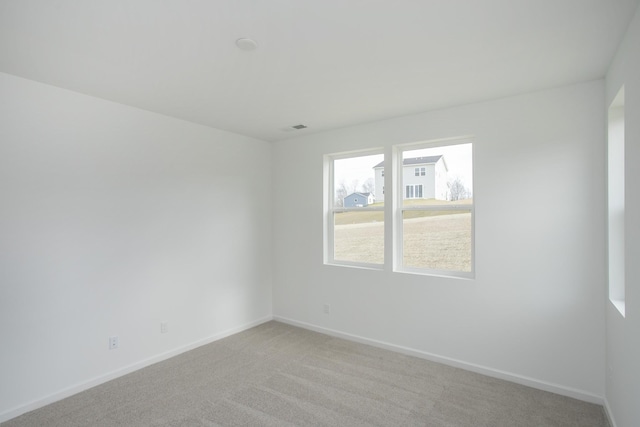 unfurnished room featuring light colored carpet