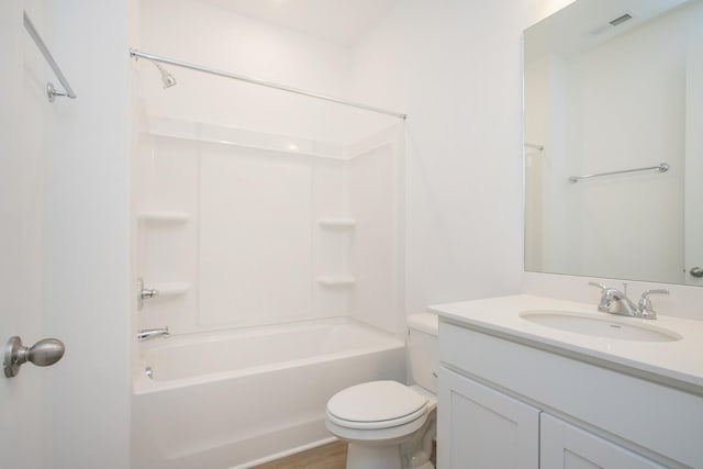 full bathroom featuring hardwood / wood-style flooring, shower / washtub combination, vanity, and toilet