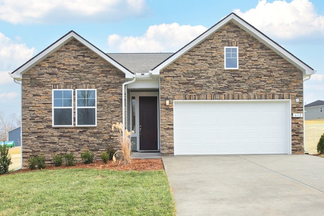 view of front of home featuring a garage and a front lawn