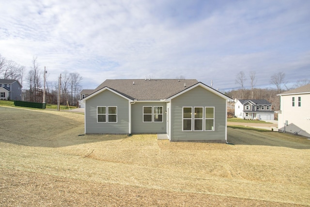 rear view of house with a yard