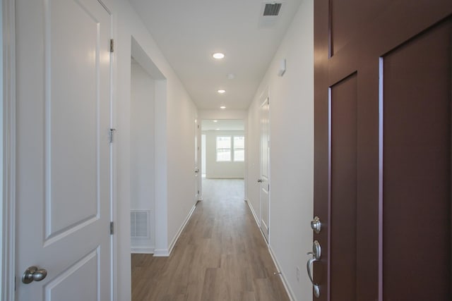 corridor with light wood-type flooring