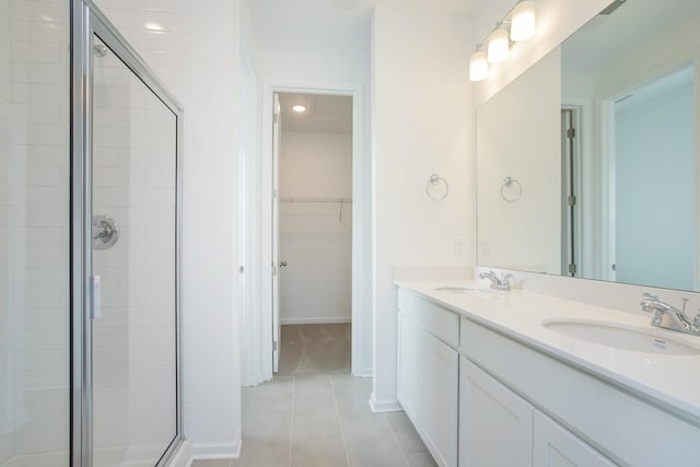 bathroom featuring an enclosed shower, vanity, and tile patterned floors