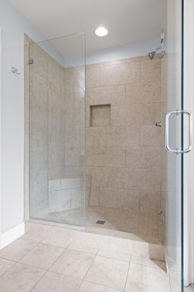 bathroom with tile patterned floors and walk in shower