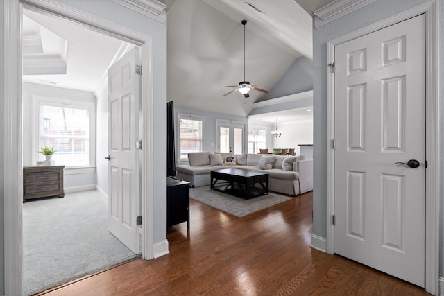 living room featuring crown molding, dark wood-type flooring, ceiling fan, vaulted ceiling, and french doors