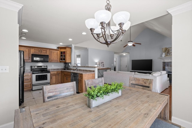 kitchen with lofted ceiling, sink, ornamental molding, black appliances, and kitchen peninsula