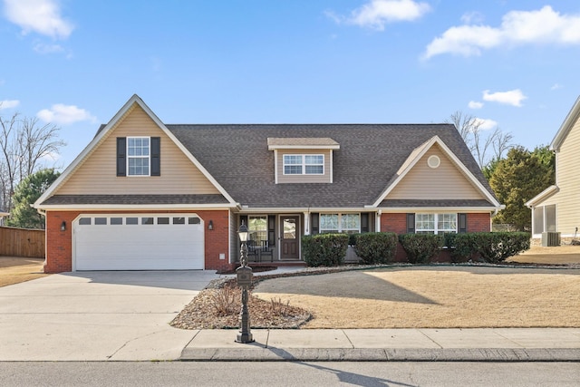 view of front of house featuring a garage and cooling unit