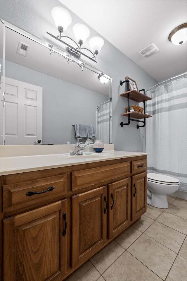 bathroom with tile patterned floors, toilet, a chandelier, and vanity