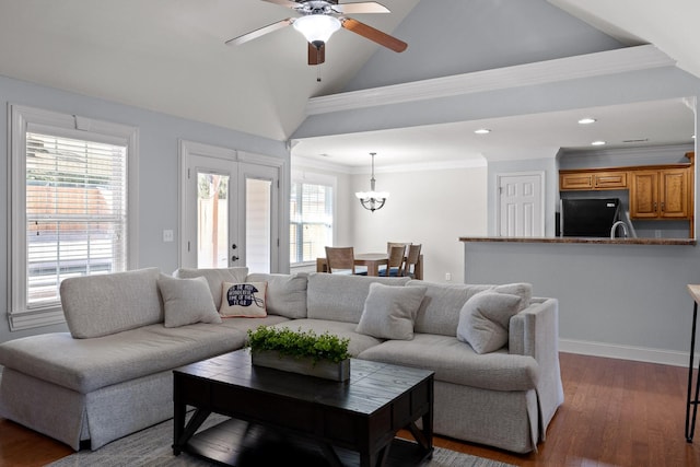 living room with crown molding, dark hardwood / wood-style floors, ceiling fan with notable chandelier, and high vaulted ceiling