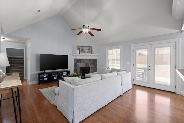 living room with french doors, high vaulted ceiling, hardwood / wood-style flooring, ceiling fan, and a fireplace