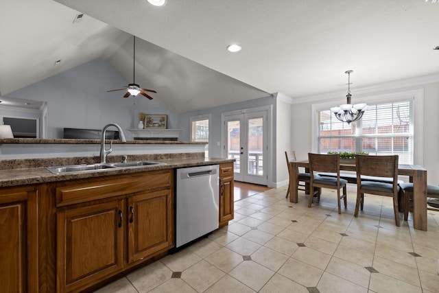 kitchen featuring vaulted ceiling, decorative light fixtures, sink, stainless steel dishwasher, and french doors