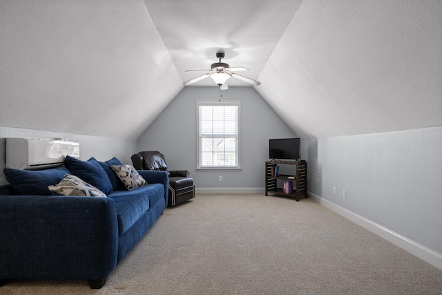 interior space with lofted ceiling, ceiling fan, and a textured ceiling