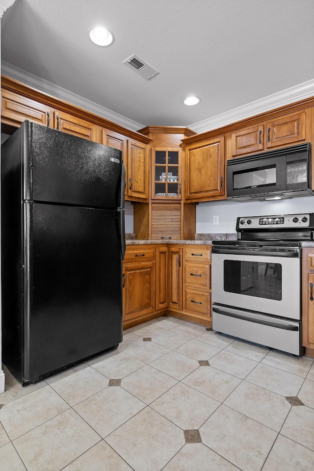 kitchen with crown molding, stone counters, light tile patterned flooring, and black appliances