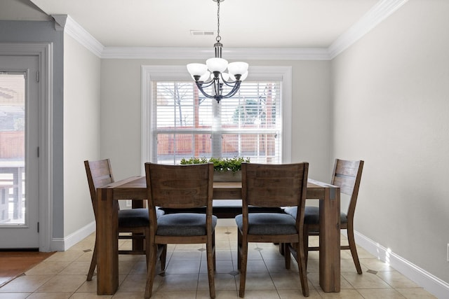 tiled dining room featuring an inviting chandelier and crown molding