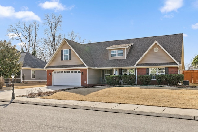 view of front of house featuring a garage and central AC