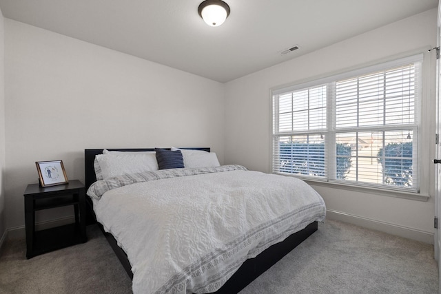 bedroom with light colored carpet